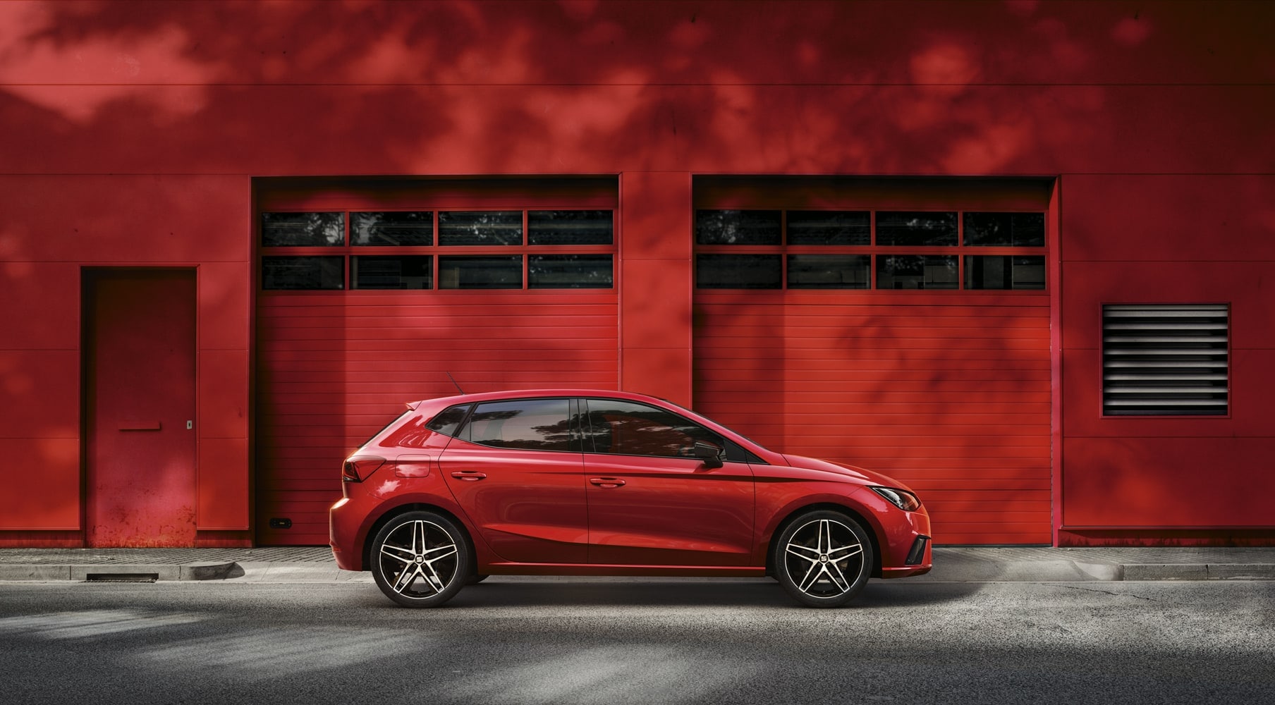 SEAT Ibiza parked outside in a red scene behind